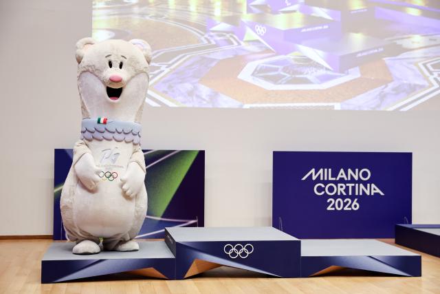 (251030) -- MILAN, Oct. 30, 2025 (Xinhua) -- Milano-Cortina 2026 Olympic Games mascot Tina is pictured standing on the newly unveiled podiums for Milano-Cortina 2026 Olympic Games during a ceremony marking 100 days to the opening of the Milano-Cortina 2026 Olympic Winter Games at Palazzo Lombardia in Milan, Italy, Oct. 29, 2025. 
A ceremony marking 100 days to the opening of the Milano-Cortina 2026 Olympic Winter Games was held at Palazzo Lombardia in Milan, where organizers unveiled the official podiums for the Olympic and Paralympic Games and introduced 12 "digital torchbearers", symbolizing the start of the final stage of preparations for the event. (Xinhua/Li Jing)