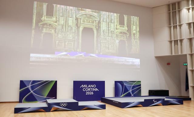 (251030) -- MILAN, Oct. 30, 2025 (Xinhua) -- Newly unveiled podiums for Milano-Cortina 2026 Olympic and Paralympic Games are seen during a ceremony marking 100 days to the opening of the Milano-Cortina 2026 Olympic Winter Games at Palazzo Lombardia in Milan, Italy, Oct. 29, 2025. 
A ceremony marking 100 days to the opening of the Milano-Cortina 2026 Olympic Winter Games was held at Palazzo Lombardia in Milan, where organizers unveiled the official podiums for the Olympic and Paralympic Games and introduced 12 "digital torchbearers", symbolizing the start of the final stage of preparations for the event. (Xinhua/Li Jing)