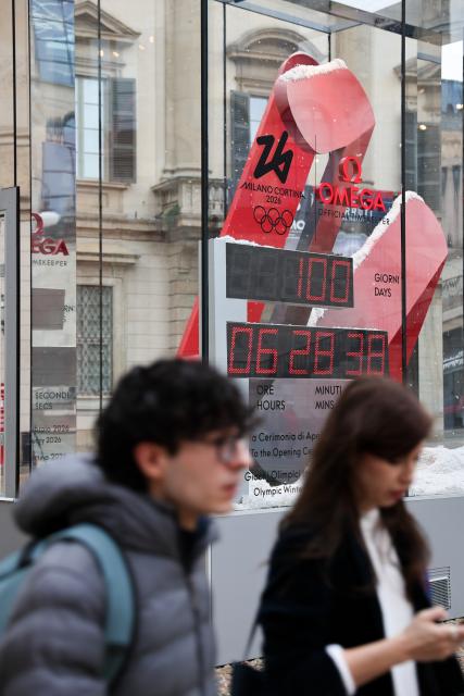 (251030) -- MILAN, Oct. 30, 2025 (Xinhua) -- People walk past the digital countdown timer of Milano-Cortina 2026 Olympic Games in Milan, Italy, Oct. 29, 2025. A ceremony marking 100 days to the opening of the Milano-Cortina 2026 Olympic Winter Games was held at Palazzo Lombardia in Milan, where organizers unveiled the official podiums for the Olympic and Paralympic Games and introduced 12 "digital torchbearers", symbolizing the start of the final stage of preparations for the event. (Xinhua/Li Jing)