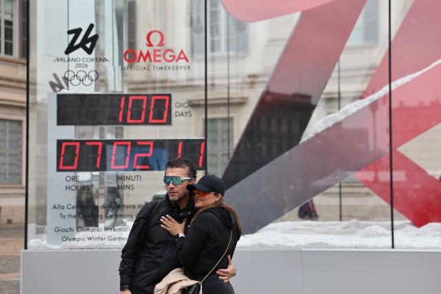 (251030) -- MILAN, Oct. 30, 2025 (Xinhua) -- People pose for photos with the digital countdown timer of Milano-Cortina 2026 Olympic Games in Milan, Italy, Oct. 29, 2025. A ceremony marking 100 days to the opening of the Milano-Cortina 2026 Olympic Winter Games was held at Palazzo Lombardia in Milan, where organizers unveiled the official podiums for the Olympic and Paralympic Games and introduced 12 "digital torchbearers", symbolizing the start of the final stage of preparations for the event. (Xinhua/Li Jing)