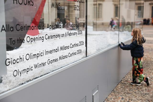 (251030) -- MILAN, Oct. 30, 2025 (Xinhua) -- A girl looks at the digital countdown timer of Milano-Cortina 2026 Olympic Games in Milan, Italy, Oct. 29, 2025. A ceremony marking 100 days to the opening of the Milano-Cortina 2026 Olympic Winter Games was held at Palazzo Lombardia in Milan, where organizers unveiled the official podiums for the Olympic and Paralympic Games and introduced 12 "digital torchbearers", symbolizing the start of the final stage of preparations for the event. (Xinhua/Li Jing)