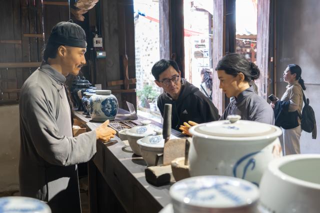 (251030) -- CHIBI, Oct. 30, 2025 (Xinhua) -- Tourists visit the ancient street in Yangloudong of Chibi City, central China's Hubei Province, Oct. 29, 2025. Yangloudong has long been renowned as the hometown of brick tea and is one of the starting points of an ancient tea road. In recent years, the area has built a new tourism model to attract tourists by creating intangible cultural heritage themed blocks and introducing diversified business formats such as Hanfu-renting and photograph. (Xinhua/Du Zixuan)