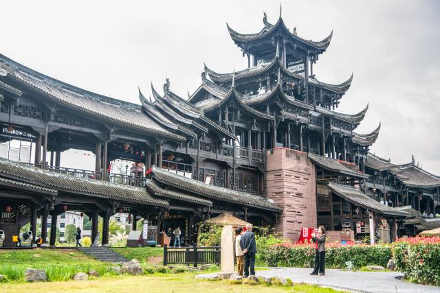 (251030) -- CHONGQING, Oct. 30, 2025 (Xinhua) -- Tourists pose for photos at the Zhuoshui ancient town in Qianjiang District, southwest China's Chongqing Municipality, Oct. 30, 2025. Situated in Qianjiang District of Chongqing, the Zhuoshui ancient town is a millennium-old town that emerged in the late Tang Dynasty (618-907) and flourished during the Ming and Qing dynasties (1368-1911).
  As a national 5A-level scenic area, the Zhuoshui ancient town has preserved its traditional architecture layout and a unique style blending stilted buildings of Tujia ethnic group and Hui-style architecture.
  In recent years, the ancient town has also leveraged its natural and cultural resources to boost local cultural tourism. Statistics show that the scenic area saw over 5 million tourist trips from January to September this year, generating a total tourism revenue of 110 million yuan (about 15.5 million U.S. dollars). (Xinhua/Tang Yi)