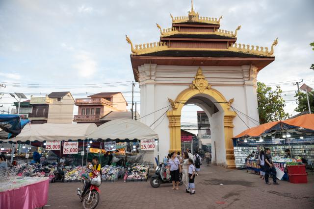 (251030) -- VIENTIANE, Oct. 30, 2025 (Xinhua) -- Street booth owners prepare for the upcoming That Luang festival in Vientiane, capital of Laos, Oct. 30, 2025. TO GO WITH: "Feature: Laos in full swing to welcome golden glow of That Luang festival " (Photo by Kaikeo Saiyasane/Xinhua)