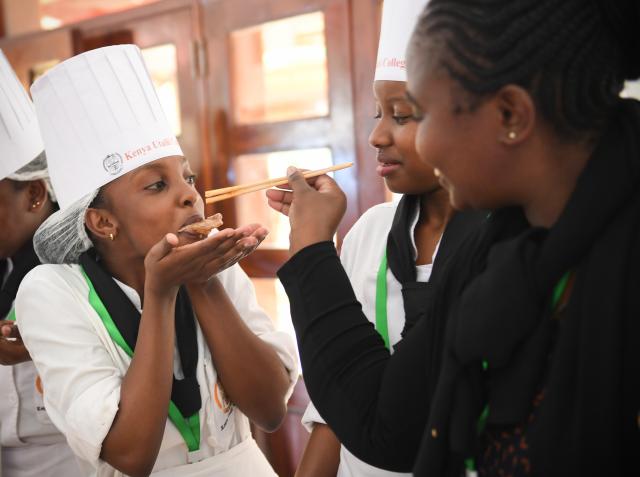 (251030) -- NAIROBI, Oct. 30, 2025 (Xinhua) -- A visitor offers food to a contestant with chopsticks during the 2025 Africa Championship of Chinese Cuisine held in Nairobi, Kenya, Oct. 30, 2025. The 2025 Africa Championship of Chinese Cuisine, the first of its kind on the continent, was held Thursday in the Kenyan capital Nairobi, highlighting the deepening cultural exchanges between China and Kenya. (Xinhua/Li Yahui)