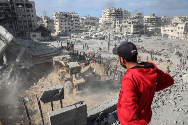 (251030) -- GAZA, Oct. 30, 2025 (Xinhua) -- Palestinians inspect destroyed houses after Israeli airstrikes, in west of Gaza City, Oct. 29, 2025. At least 100 Palestinians were killed in Israeli attacks across the Gaza Strip from late Tuesday to Wednesday, marking the most intense escalation since the ceasefire agreement took effect on October 10. (Photo by Rizek Abdeljawad/Xinhua)