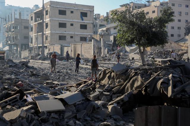 (251030) -- GAZA, Oct. 30, 2025 (Xinhua) -- Palestinians inspect destroyed houses after Israeli airstrikes, in west of Gaza City, Oct. 29, 2025. At least 100 Palestinians were killed in Israeli attacks across the Gaza Strip from late Tuesday to Wednesday, marking the most intense escalation since the ceasefire agreement took effect on October 10. (Photo by Rizek Abdeljawad/Xinhua)