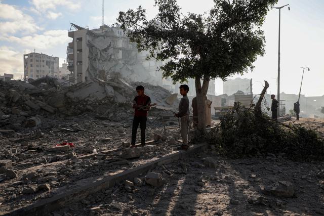 (251030) -- GAZA, Oct. 30, 2025 (Xinhua) -- Palestinians inspect destroyed houses after Israeli airstrikes, in west of Gaza City, Oct. 29, 2025. At least 100 Palestinians were killed in Israeli attacks across the Gaza Strip from late Tuesday to Wednesday, marking the most intense escalation since the ceasefire agreement took effect on October 10. (Photo by Rizek Abdeljawad/Xinhua)