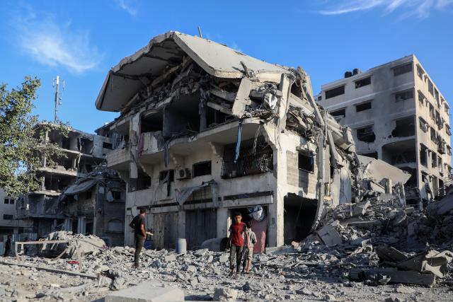(251030) -- GAZA, Oct. 30, 2025 (Xinhua) -- Palestinians inspect destroyed houses after Israeli airstrikes, in west of Gaza City, Oct. 29, 2025. At least 100 Palestinians were killed in Israeli attacks across the Gaza Strip from late Tuesday to Wednesday, marking the most intense escalation since the ceasefire agreement took effect on October 10. (Photo by Rizek Abdeljawad/Xinhua)