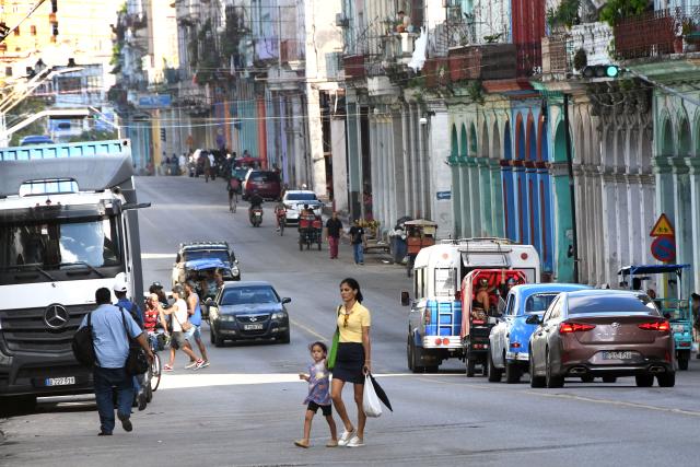 (251030) -- HAVANA, Oct. 30, 2025 (Xinhua) -- A woman with a girl passes a street in Havana, capital of Cuba, on Oct. 29, 2025. The UN General Assembly (UNGA) adopted a draft resolution on Wednesday urging the United States to end its economic, commercial and financial embargo against Cuba. Since 1992, the UNGA has adopted by an overwhelming majority the non-binding annual resolution, urging the United States to end its embargo against Cuba imposed since 1962. (Photo by Joaquin Hernandez/Xinhua)