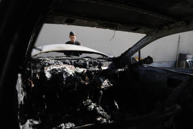 (251031) -- HEBRON, Oct. 31, 2025 (Xinhua) -- A Palestinian inspects a damaged vehicle after Israeli settlers burnt it, in the town of Surif, northwest of Hebron, in the West Bank, on Oct. 29, 2025. (Photo by Mamoun Wazwaz/Xinhua)