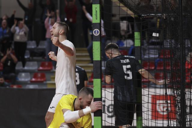 (251031) -- LJUBLJANA, Oct. 31, 2025 (Xinhua) -- Tod Ciuha (L) of Vrhnika celebrates after scoring during the UEFA Futsal Champions League Main Round Group 8 match between Vrhnika of Slovenia and Forca of North Macedonia in Ljubljana, Slovenia, Oct. 30, 2025. (Photo by Zeljko Stevanic/Xinhua)