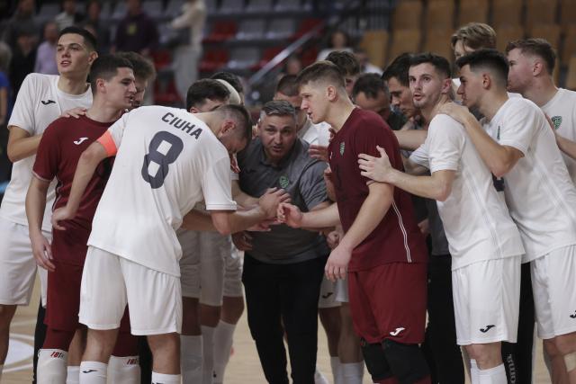 (251031) -- LJUBLJANA, Oct. 31, 2025 (Xinhua) -- Players of Vrhnika celebrate the victory with their coach after the UEFA Futsal Champions League Main Round Group 8 match between Vrhnika of Slovenia and Forca of North Macedonia in Ljubljana, Slovenia, Oct. 30, 2025. (Photo by Zeljko Stevanic/Xinhua)