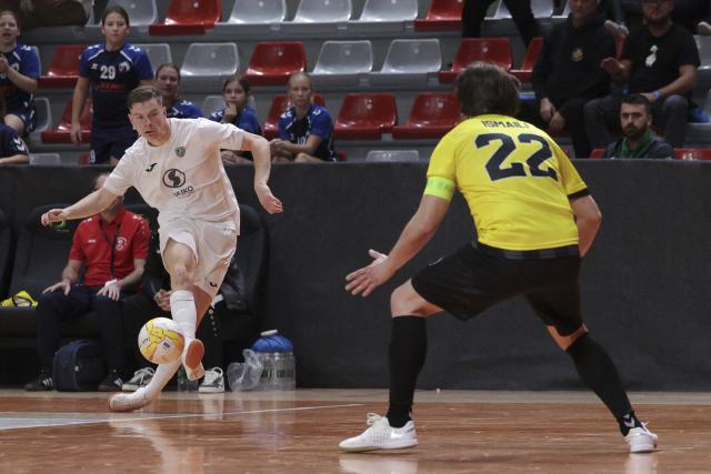 (251031) -- LJUBLJANA, Oct. 31, 2025 (Xinhua) -- Jure Suban (L) of Vrhnika shoots during the UEFA Futsal Champions League Main Round Group 8 match between Vrhnika of Slovenia and Forca of North Macedonia in Ljubljana, Slovenia, Oct. 30, 2025. (Photo by Zeljko Stevanic/Xinhua)