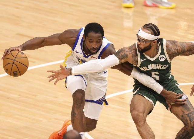(251031) -- MILWAUKEE, Oct. 31, 2025 (Xinhua) -- Golden State Warriors' Jonathan Kuminga (L) is defended by Milwaukee Bucks' Gary Trent Jr. during the 2025-2026 NBA regular season game between Milwaukee Bucks and Golden State Warriors in Milwaukee, the United States, on Oct. 30, 2025. (Photo by Joel Lerner/Xinhua)