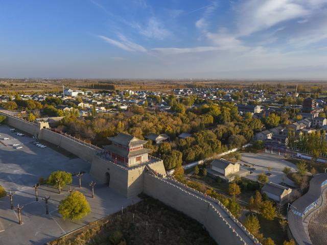 (251031) -- QAPQAL, Oct. 31, 2025 (Xinhua) -- Wu Junliang is a 37-year-old archer from Qapqal Xibe Autonomous County, a border county in northwest China's Xinjiang Uygur Autonomous Region - also proudly known as the hometown of Chinese archery. Wu is a recognized inheritor of the national intangible cultural heritage "Traditional Xibe Archery" and he has joined the "heritage-in-schools" initiative, offering free archery training to primary school students. He is called the "champion coach" by students.
Recognized for his strong arms and steady composure, Wu was admitted to a local archery school at the age of 16 to receive professional training. With outstanding talent, he quickly emerged, winning gold and silver medals in competitions at various levels. After retiring, he was hired as an archery coach for visitors at the Xibe Ancient Town.
For over a decade, Wu further studied traditional bows and taught himself multiple skills including horseback archery and rapid shooting at moving targets. As traditional bow competitions increased, he participated nationwide, winning multiple championships and training a number of apprentices. 
As intangible-heritage tourism gains popularity in recent years, Wu opened a 300-square-meter archery club in Yining City earlier this year, highlighting traditional bow culture. This aerial drone photo taken on Oct. 24, 2025 shows the scenery of the Xibe Ancient Town, a cultural heritage site showcasing the history of the Xibe people's westward migration and border defense. (Xinhua/Hu Huhu)