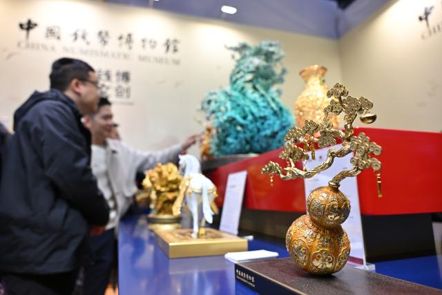 (251031) -- BEIJING, Oct. 31, 2025 (Xinhua) -- This photo taken on Oct. 31, 2025 shows creative cultural products of China Numismatic Museum during the Beijing International Coin Exposition 2025 at the China National Convention Center in Beijing, capital of China. The three-day exposition kicked off here on Friday, attracting 323 exhibitors from 21 countries and regions. (Xinhua/Li Xin)