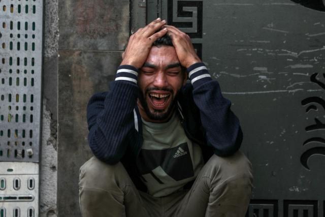 (251101) -- BEIJING, Nov. 1, 2025 (Xinhua) -- A Palestinian mourns over victims killed during Israeli airstrikes, at al-Shifa hospital in west of Gaza City, Oct. 29, 2025. At least 100 Palestinians were killed in Israeli attacks across the Gaza Strip from late Tuesday to Wednesday, marking the most intense escalation since the ceasefire agreement took effect on October 10. (Photo by Rizek Abdeljawad/Xinhua)