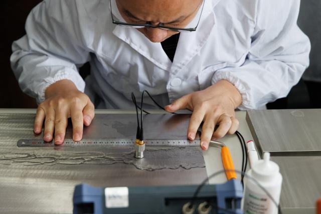 (251101) -- SHANGHAI, Nov. 1, 2025 (Xinhua) -- A researcher checks the welding quality of alloy materials used in building the Thorium Molten Salt Reactor, at a laboratory of the Jiading campus of the Chinese Academy of Sciences' Shanghai Institute of Applied Physics (SINAP) in east China's Shanghai, Oct. 23, 2025. China has successfully achieved the first-ever thorium to uranium nuclear fuel conversion in a Thorium Molten Salt Reactor (TMSR), and obtained valid experimental data following thorium fuel loading, confirming the technical feasibility of thorium utilization in a molten-salt reactor nuclear energy system, according to the Chinese Academy of Sciences' Shanghai Institute of Applied Physics (SINAP) on Saturday. 
   TO GO WITH "China achieves thorium-uranium nuclear fuel conversion in molten-salt reactor" (Xinhua/Jin Liwang)