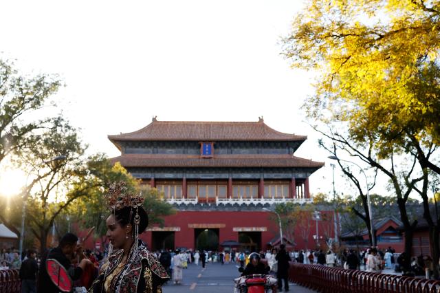 (251101) -- BEIJING, Nov. 1, 2025 (Xinhua) -- Ethiopian tourist Betty wearing traditional Chinese costumes enjoys her photoshoot experience outside Donghua Gate, as known as East Prosperity Gate of the Palace Museum in Beijing, capital of China, Nov. 1, 2025. From January to September 2025, Beijing has received approximately 3.88 million inbound tourists, a year-on-year increase of 42.9 percent, according to Beijing Municipal Bureau of Culture and Tourism. (Xinhua/Wang Lili)