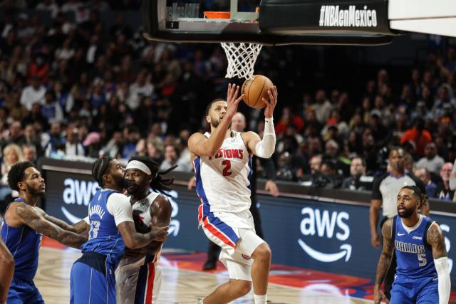 (251102) -- MEXICO CITY, Nov. 2, 2025 (Xinhua) -- Detroit Pistons' Cade Cunningham (top) goes for a lay-up during the 2025-2026 NBA regular season match between Detroit Pistons and Dallas Mavericks in Mexico City, capital of Mexico, on Nov. 1, 2025. (Photo by Francisco Canedo/Xinhua)
