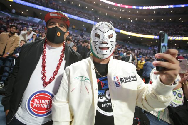 (251102) -- MEXICO CITY, Nov. 2, 2025 (Xinhua) -- Spectators take selfies before the 2025-2026 NBA regular season match between Detroit Pistons and Dallas Mavericks in Mexico City, capital of Mexico, on Nov. 1, 2025. (Photo by Francisco Canedo/Xinhua)