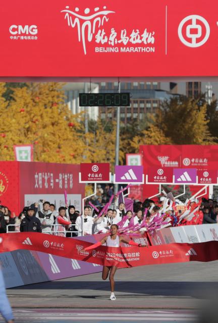 (251102) -- BEIJING, Nov. 2, 2025 (Xinhua) -- Anchinalu Dessie Genaneh of Ethiopia crosses the finish line to win the first place of the women's marathon during the Beijing Marathon 2025 in Beijing, capital of China, Nov. 2, 2025. (Xinhua/Guo Yu)