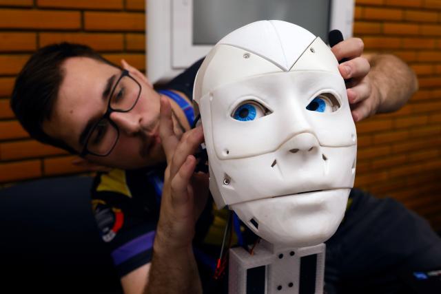 (251102) -- BUCHAREST, Nov. 2, 2025 (Xinhua) -- A participant manipulates his humanoid robot head during the 4th edition of the Robofest, a technology festival, at the Politehnica University of Bucharest in Bucharest, Romania, Nov. 1, 2025. The three-day festival including the 16th edition of the Robochallenge is held here from Oct. 31 to Nov. 2. (Photo by Cristian Cristel/Xinhua)