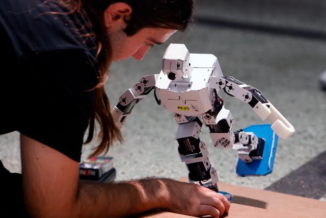 (251102) -- BUCHAREST, Nov. 2, 2025 (Xinhua) -- A participant prepares his robot for a contest during the 4th edition of the Robofest, a technology festival, at the Politehnica University of Bucharest in Bucharest, Romania, Nov. 1, 2025. The three-day festival including the 16th edition of the Robochallenge is held here from Oct. 31 to Nov. 2. (Photo by Cristian Cristel/Xinhua)