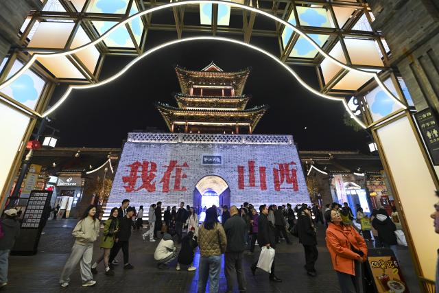 (251102) -- TAIYUAN, Nov. 2, 2025 (Xinhua) -- People visit Zhonglou Street in Taiyuan, north China's Shanxi Province, Oct. 29, 2025. As both a commercial hub and cultural landmark of Taiyuan, Zhonglou Street carries a millennium of local history. However, rapid urban development once left it struggling with aging facilities, narrow spaces, and traffic congestion.
     In 2020, Taiyuan launched a renovation project for the area, and by September of 2021, the historic street renewed with a fresh look. The upgrade preserved the traditional street layout and architectural style while integrating modern elements and functions, attracting numerous locals and tourists daily.
    In 2022, Zhonglou Street was listed among the second batch of national nighttime cultural and tourism consumption clusters. In 2023, it was included in the second batch of national-level tourism and leisure blocks. During this year's National Day holiday, nearly 900,000 visits were made to the street, cementing its status as a true "city living room." (Xinhua/Yang Chenguang)
