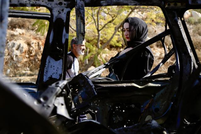 (251103) -- BEIRUT, Nov. 3, 2025 (Xinhua) -- A woman stands beside the wreckage of a car bombed by an Israeli drone in Kfar Roummane, southern Lebanon, Nov. 2, 2025.
  Four people were killed and three others injured on Saturday night in an Israeli airstrike on the southern Lebanese village of Kfar Roummane, the country's Public Health Emergency Operations Center reported.
  According to the National News Agency (NNA), an Israeli drone carried out the airstrike at around 10:20 p.m. local time (2020 GMT) on Saturday, targeting a four-wheel-drive vehicle with a guided missile on the Doha-Kfar Roummane road, on the eastern outskirts of the village. (Photo by Ali Hashisho/Xinhua)