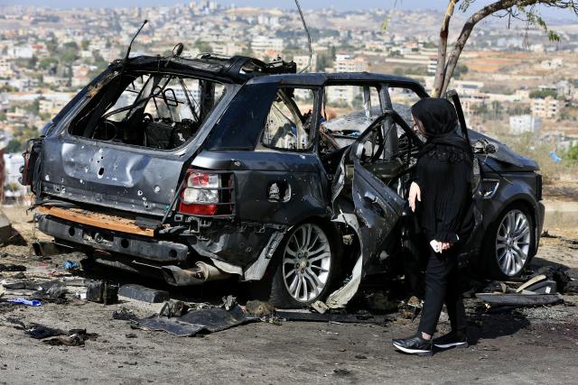 (251103) -- BEIRUT, Nov. 3, 2025 (Xinhua) -- A woman stands beside the wreckage of a car bombed by an Israeli drone in Kfar Roummane, southern Lebanon, Nov. 2, 2025.
  Four people were killed and three others injured on Saturday night in an Israeli airstrike on the southern Lebanese village of Kfar Roummane, the country's Public Health Emergency Operations Center reported.
  According to the National News Agency (NNA), an Israeli drone carried out the airstrike at around 10:20 p.m. local time (2020 GMT) on Saturday, targeting a four-wheel-drive vehicle with a guided missile on the Doha-Kfar Roummane road, on the eastern outskirts of the village. (Photo by Ali Hashisho/Xinhua)