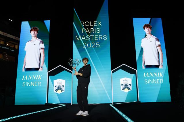 (251103) -- PARIS, Nov. 3, 2025 (Xinhua) -- Jannik Sinner poses with the trophy after the final match between Jannik Sinner of Italy and Felix Auger-Aliassime of Canada at the Paris ATP Masters 1000 tennis tournament at Paris La Defense Arena in Paris, France, on Nov. 2, 2025. (Xinhua/Gao Jing)