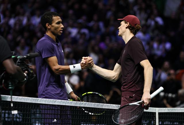 (251103) -- PARIS, Nov. 3, 2025 (Xinhua) -- Jannik Sinner (R) of Italy greets Felix Auger-Aliassime of Canada after their final match the final match between Jannik Sinner of Italy and Felix Auger-Aliassime of Canada at the Paris ATP Masters 1000 tennis tournament at Paris La Defense Arena in Paris, France, on Nov. 2, 2025. (Xinhua/Gao Jing)