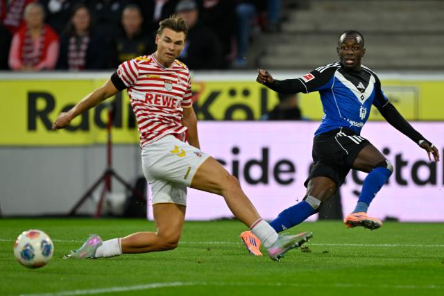 (251103) -- COLOGNE, Nov. 3, 2025 (Xinhua) -- Joel Schmied (L) of FC Cologne vies with Jean-Luc Dompe of Hamburger SV during the German first division Bundesliga football match between FC Cologne and Hamburger SV in Cologne, Germany, on Nov. 2, 2025. (Photo by Ulrich Hufnagel/Xinhua)