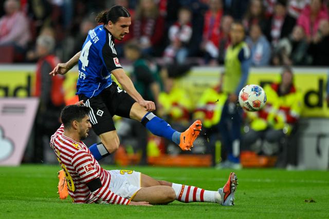 (251103) -- COLOGNE, Nov. 3, 2025 (Xinhua) -- Cenk Ozkacar (bottom) of FC Cologne vies with Rayan Philippe of Hamburger SV during the German first division Bundesliga football match between FC Cologne and Hamburger SV in Cologne, Germany, on Nov. 2, 2025. (Photo by Ulrich Hufnagel/Xinhua)