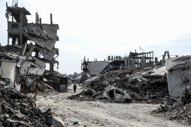 (251103) -- GAZA, Nov. 3, 2025 (Xinhua) -- A Palestinian walks on a path flanked by destroyed buildings in the Jabalia refugee camp in northern Gaza on Nov. 2, 2025. (Photo by Rizek Abdeljawad/Xinhua)