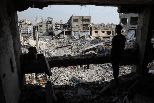 (251103) -- GAZA, Nov. 3, 2025 (Xinhua) -- A Palestinian stands in a destroyed building in the Jabalia refugee camp in northern Gaza on Nov. 2, 2025. (Photo by Rizek Abdeljawad/Xinhua)