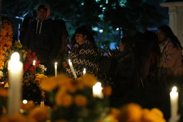 (251103) -- MEXICO CITY, Nov. 3, 2025 (Xinhua) -- People hold a vigil at a cemetery as part of the Day of the Dead commemorations in Mexico City, capital of Mexico, Nov. 2, 2025. (Photo by Francisco Canedo/Xinhua)