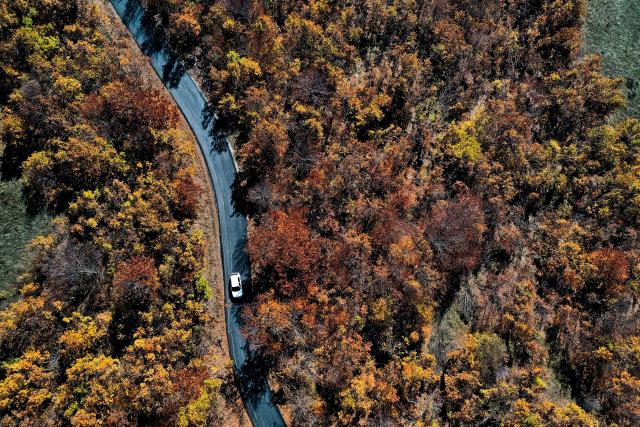 (251103) -- SKOPJE, Nov. 3, 2025 (Xinhua) -- An aerial drone photo shows a car running on a road at Skopska Crna Gora, some 35 km from the capital of Skopje in North Macedonia, on Nov. 2, 2025. (Photo by Tomislav Georgiev/Xinhua)