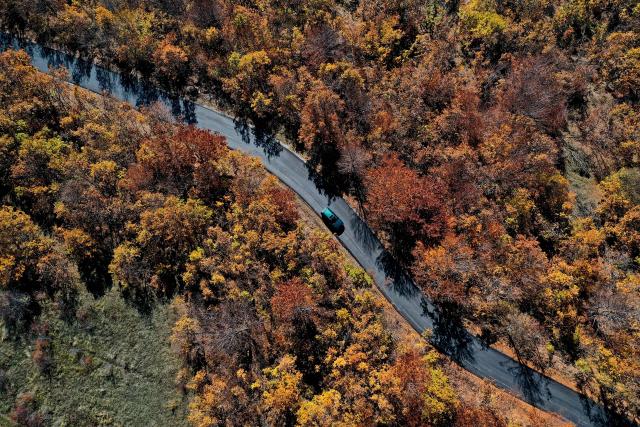 (251103) -- SKOPJE, Nov. 3, 2025 (Xinhua) -- An aerial drone photo shows a car running on a road at Skopska Crna Gora, some 35 km from the capital of Skopje in North Macedonia, on Nov. 2, 2025. (Photo by Tomislav Georgiev/Xinhua)