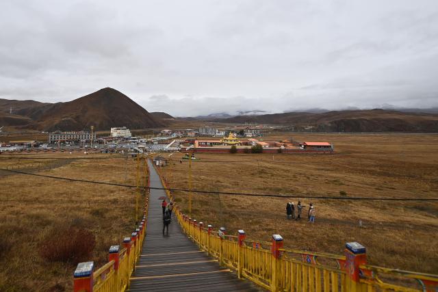 (251103) -- GANZI, Nov. 3, 2025 (Xinhua) -- People visit a grassland scenic spot in Kangding City, Ganzi Tibetan Autonomous Prefecture, southwest China's Sichuan Province, Oct. 31, 2025. In recent years, Ganzi Tibetan Autonomous Prefecture has leveraged its natural scenic advantages to develop its cultural and tourism industry. From January to October this year, the prefecture has received over 40 million tourist trips, setting a new record for the same period. (Xinhua/Xiao Xiao)