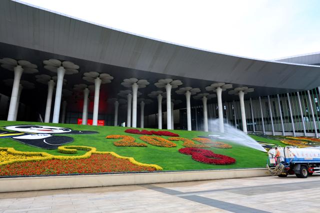 (251103) -- SHANGHAI, Nov. 3, 2025 (Xinhua) -- A staff member sprays water to the green area at the south square of the National Exhibition and Convention Center (Shanghai), the main venue for the eighth China International Import Expo (CIIE), in east China's Shanghai, Nov. 3, 2025. The eighth CIIE will be held in Shanghai from Nov. 5 to 10. The event this year will feature 4,108 overseas exhibitors from 155 countries, regions and international organizations, with the total exhibition area exceeding 430,000 square meters, setting a new record in scale. (Xinhua/Fang Zhe)