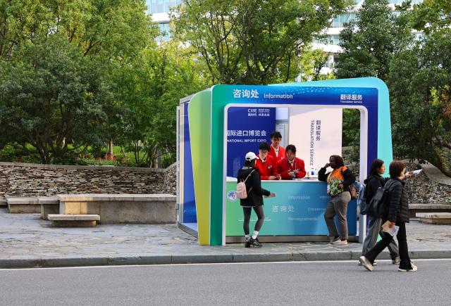 (251103) -- SHANGHAI, Nov. 3, 2025 (Xinhua) -- Volunteers work at an information booth of the National Exhibition and Convention Center (Shanghai), the main venue for the eighth China International Import Expo (CIIE), in east China's Shanghai, Nov. 3, 2025. The eighth CIIE will be held in Shanghai from Nov. 5 to 10. The event this year will feature 4,108 overseas exhibitors from 155 countries, regions and international organizations, with the total exhibition area exceeding 430,000 square meters, setting a new record in scale. (Xinhua/Fang Zhe)