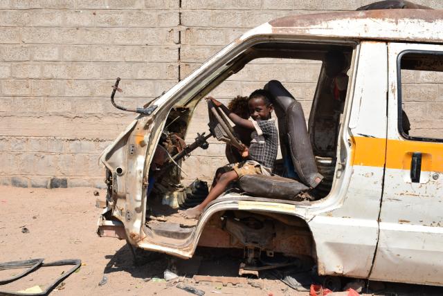 (251103) -- ADEN(YEMEN), Nov. 3, 2025 (Xinhua) -- Children sit inside a broken vehicle used as a play area at a displacement camp on the outskirts of Aden, Yemen, Nov. 3, 2025. TO GO WITH "Feature: Bitter cold, tattered tents -- displaced Yemenis brace for harsher winter" (Photo by Murad/Xinhua)