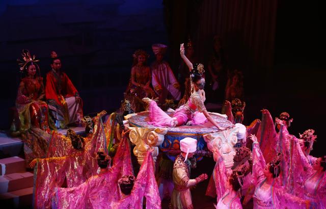 (251104) -- LANZHOU, Nov. 4, 2025 (Xinhua) -- The dance drama "Flower Rains Along Silk Road" is staged at the Peacock Theatre in London, Britain, Jan. 11, 2014.
  Dunhuang dance refers to a dance style that aims to bring to life the iconic figures depicted on the ancient murals of the Mogao Grottoes, which is a 1,600-year-old UNESCO World Heritage site in Dunhuang.
  Drawing on historical themes, contemporary artists have created four awe-inspiring music and dance masterpieces, which include the classic dance drama "Flower Rains Along Silk Road," whose footprints have covered more than 40 countries and regions since its debut in 1979, and "the Thousand-Hand Bodhisattva" performed by dancers with hearing or visual impairment.
  Last year, the four classic performing arts attracted more than 1.14 million visitors to Dunhuang, with a record of over 2,000 performances, according to data from the cultural and tourism department of Gansu Province. Through these cultural and visual feasts, tourists are immersed in the history of the ancient Silk Road, carrying forward Dunhuang's ongoing journey of cultural preservation.
  The introduction of Dunhuang dance to local educational institutions also fuels the boom. The unique dance genre has been passed down among young generations, promoting it to a wider audience so that more people will learn about the beauty of Dunhuang. (Xinhua/Yin Gang)