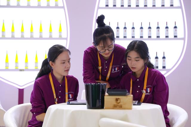 (251104) -- SHANGHAI, Nov. 4, 2025 (Xinhua) -- Staff members of a French wine exhibitor make preparations at their booth of the eighth China International Import Expo (CIIE) in east China's Shanghai, on Nov. 4, 2025. The eighth CIIE will be held in Shanghai from Nov. 5 to 10. (Xinhua/Wang Jingqiang)