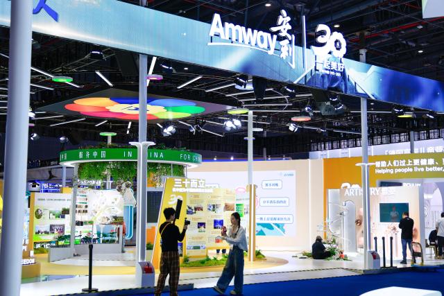 (251104) -- SHANGHAI, Nov. 4, 2025 (Xinhua) -- Staff members record videos in front of a booth at the eighth China International Import Expo (CIIE) in east China's Shanghai, on Nov. 4, 2025. The eighth CIIE will be held in Shanghai from Nov. 5 to 10. (Xinhua/Liu Jiaqi)