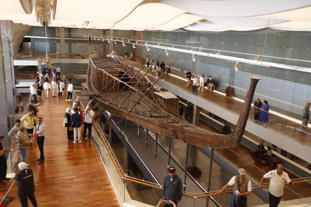 (251104) -- CAIRO, Nov. 4, 2025 (Xinhua) -- Tourists visit King Khufu's solar boat at the Grand Egyptian Museum in Giza, Egypt, on Nov. 4, 2025. The Grand Egyptian Museum (GEM) , the world's largest museum dedicated to a single civilization, opened to the public on Tuesday. (Xinhua/Ahmed Gomaa)