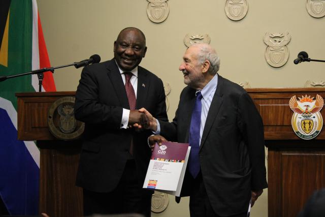 (251104) -- CAPE TOWN, Nov. 4, 2025 (Xinhua) -- South African President Cyril Ramaphosa (L) receives the G20 Extraordinary Committee Report on Global Inequality from Nobel Laureate Joseph Stiglitz  at a ceremony in Cape Town, South Africa, on Nov. 4, 2025. A G20 report commissioned under South Africa's presidency has sounded the alarm over an escalating global inequality crisis, calling for the creation of a new international panel to guide policymaking at both national and global levels. (Photo by Shakirah Thebus/Xinhua)